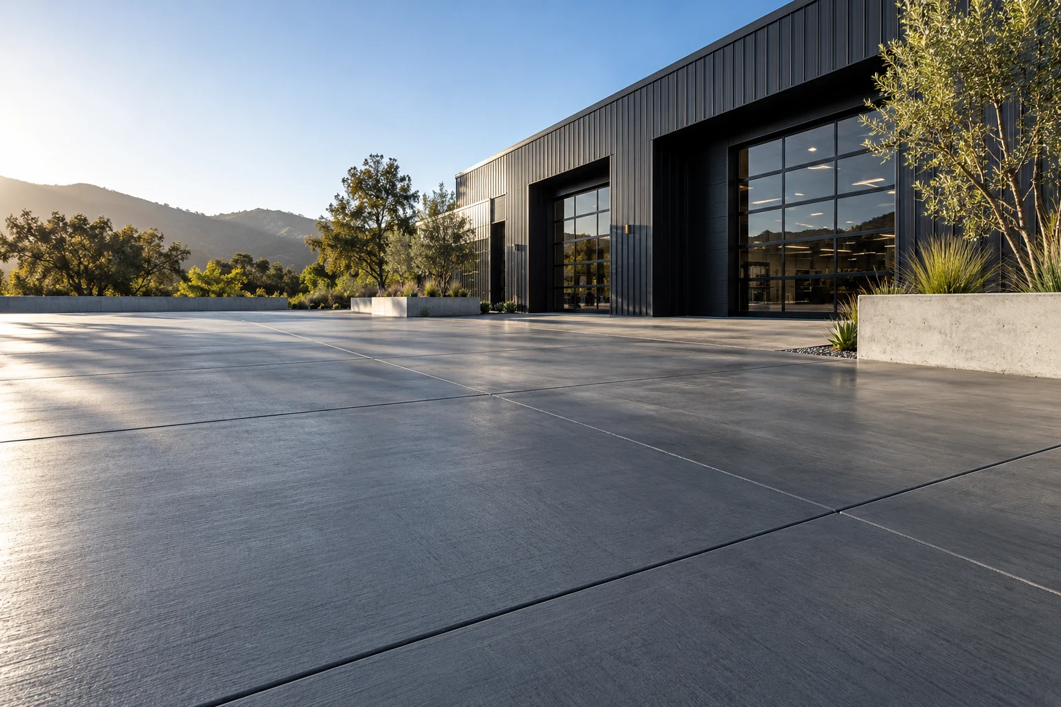 Finished concrete forecourt outside a modern workshop, illustrative concrete concept